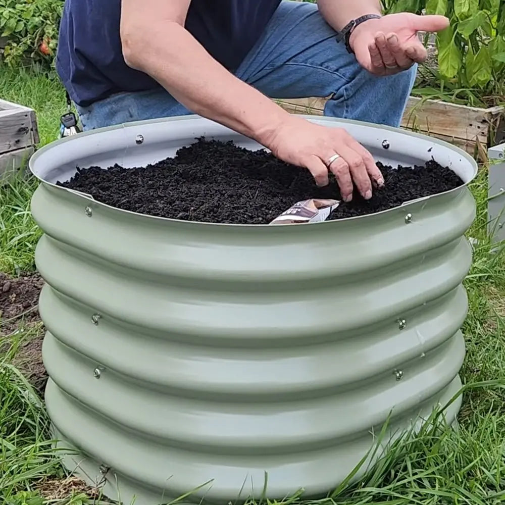 place seeds in 24-inch wide round metal raised garden bed-Vegega