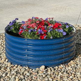 blue round raised garden bed growing flowers-Vegega